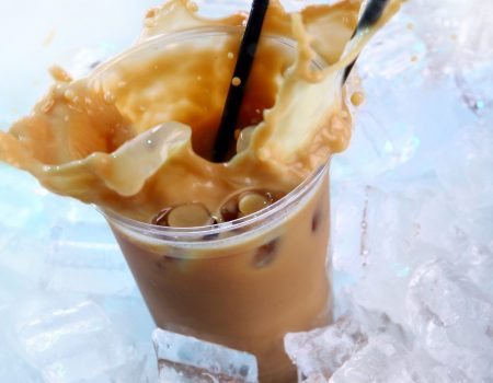 Cold coffee drink with ice and splashes